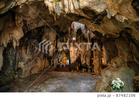 Stalactite limestone cave with buddha statue Stalactite limestone cave with buddha statue 87482106