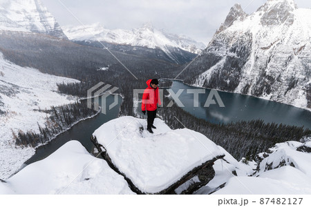 Traveler man in red jacket standing on peak of Opabin Plateau in blizzard at Yoho national park 87482127