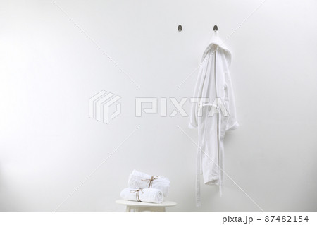 Soft comfortable bathrobe and towels indoors, space for text Soft comfortable bathrobe and towels indoors, space for text 87482154