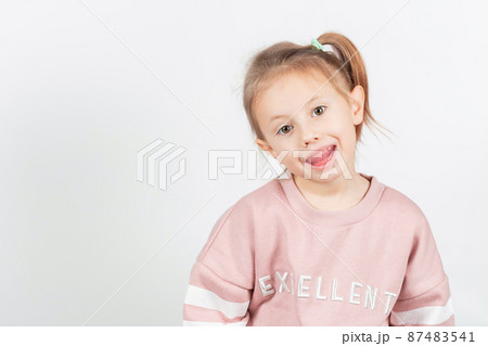 Little girl shows myofunctional trainer. dental tariner is made to correct bite Little girl shows myofunctional trainer. dental tariner is made to correct bite 87483541
