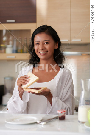 Woman Making Strawberry Jam Toast 87484444