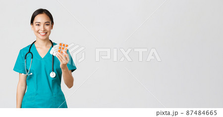 Healthcare workers, preventing virus, quarantine campaign concept. Friendly-looking female asian nurse, doctor explain patient medication prescription, showing drugs and smiling, white background Healthcare workers, preventing virus, quarantine campaign concept. Friendly-looking female asian nurse, doctor explain patient medication prescription, showing drugs and smiling, white background 87484665