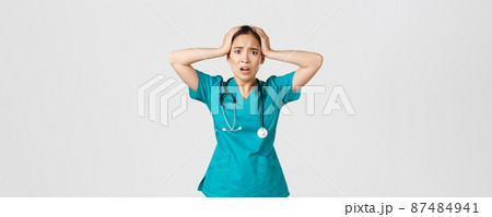 Covid-19, healthcare workers and preventing virus concept. Distressed and pressured asian female nurse, intern grab head in panic and grimacing, feeling anxious, have big problem Covid-19, healthcare workers and preventing virus concept. Distressed and pressured asian female nurse, intern grab head in panic and grimacing, feeling anxious, have big problem 87484941