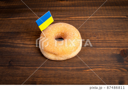 Ukrainian flag is inserted in the donut. Politics and crisis situation, abstract background 87486811