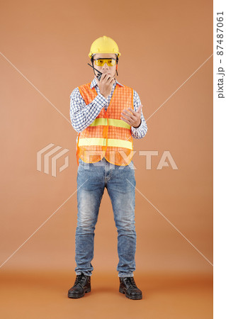 Contractor Talking on Walkie-Talkie Contractor Talking on Walkie-Talkie 87487061