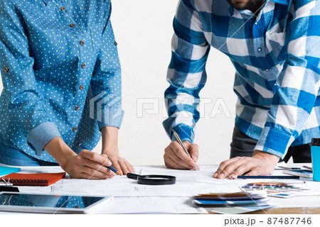 Man writing with pen on technical drawing Man writing with pen on technical drawing 87487746