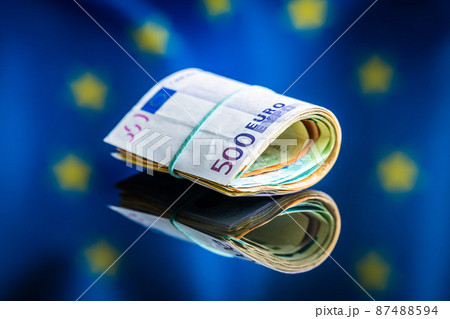 Euro banknotes in front of Europe union flag. Paper European currency. 87488594