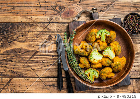 Breadcrumb broccoli in a wooden plate with thyme. wooden background. Top view. Copy space Breadcrumb broccoli in a wooden plate with thyme. wooden background. Top view. Copy space 87490219