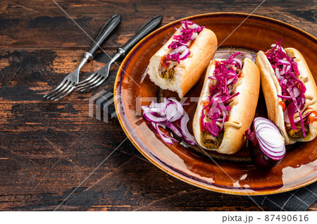 Street food - Vegan hot-dogs with cabbage and meatless sausage. Dark Wooden background. Top view. Copy space 87490616