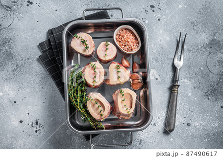 Raw beef Marrow bones in kitchen tray ready for cooking. Gray background. Top view 87490617