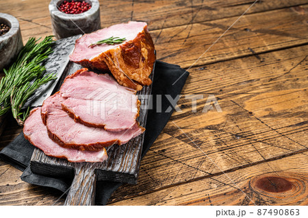 Cold Smoked pork sirloin meat with herbs on rustic board. Wooden background. Top view. Copy space 87490863