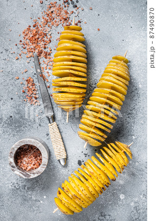 Uncooked raw Tornado or Twist potato fries. Wooden background. Top view. Copy space Uncooked raw Tornado or Twist potato fries. Wooden background. Top view. Copy space 87490870