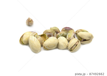 Green pistachios isolated on a white background. 87492662
