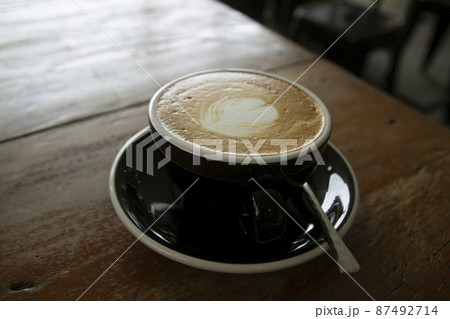 hot coffee cup on wooden table in coffee shop hot coffee cup on wooden table in coffee shop 87492714