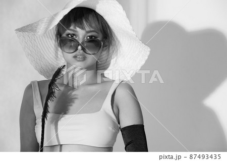 Half body Asian Woman 20s wear Bikini sunglasses beach hat and gloves stay in sun and reflect 87493435