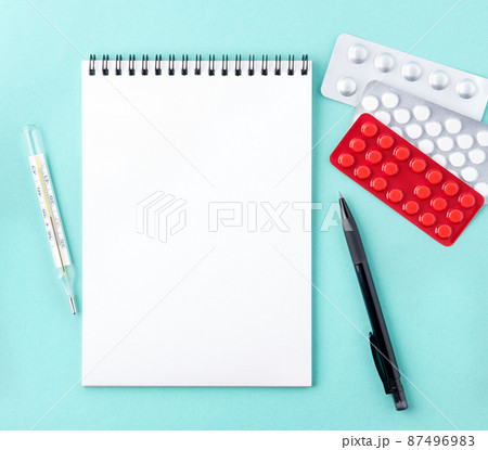 open notebook with blank white clean page to write the treatment plan of the disease. 87496983