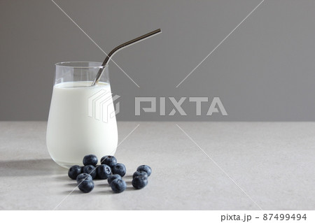 Milk and blueberries on the table. Vegan or vegetarian milk. Vegetables milk. Milk and blueberries on the table. Vegan or vegetarian milk. Vegetables milk. 87499494