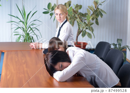 Tired young business ladies in office Tired young business ladies in office 87499528