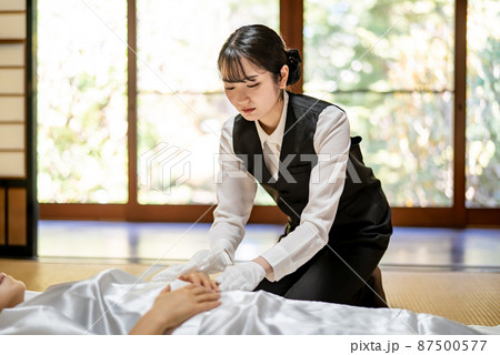 仏衣を着せる葬儀スタッフ（納棺師・手甲） 87500577