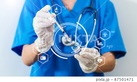COVID-19 vaccine in researcher hands, female doctor holds syringe and bottle with vaccine for coronavirus cure. 87501471