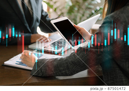 Two professional traides on technical price graph and indicator, red and green candlestick chart and stock trading computer 87501472