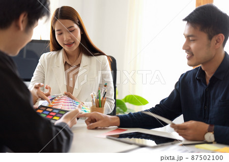 Group of graphic designers brainstorming and meeting in the office 87502100