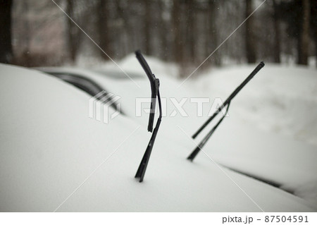 Brushes on car. Car is in snow. Safety of brushes in cold. 87504591
