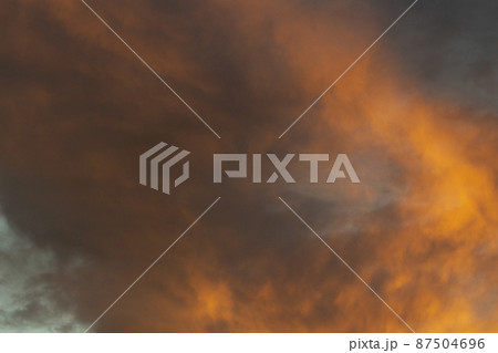Fiery clouds. Sunset light. Orange sky. Landscape sunset colors. 87504696