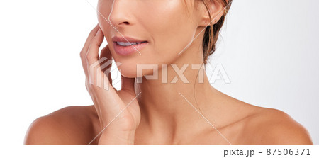 Treating my skin delicately. Cropped shot of an unrecognizable woman posing alone in the studio. Treating my skin delicately. Cropped shot of an unrecognizable woman posing alone in the studio. 87506371
