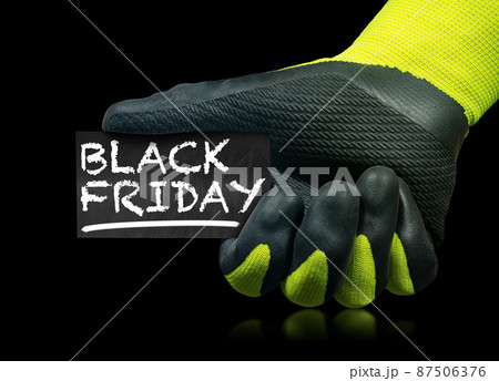 Gloved Hand Holding a Black Friday Sign isolated on Black Background 87506376
