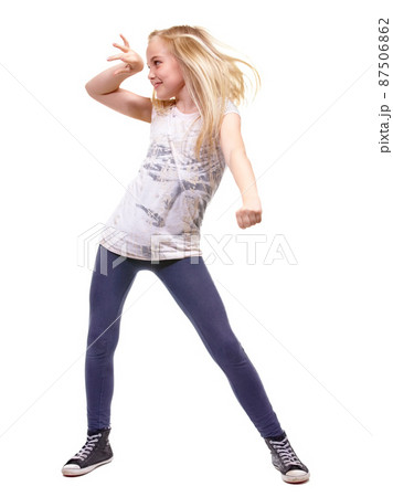 Lets party. Full length shot a young girl dancing against white background. 87506862