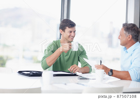 Learning from experience. A young office worker discussing ideas with his boss. Learning from experience. A young office worker discussing ideas with his boss. 87507108