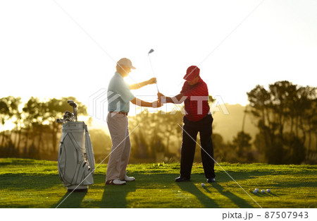 Keep the club level right through your swing. A male golfer receiving help from his caddy on the golf course. Keep the club level right through your swing. A male golfer receiving help from his caddy on the golf course. 87507943