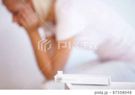 The pregnancy test revealed her worst fear. A young woman waiting anxiously for the results of her pregnancy test. The pregnancy test revealed her worst fear. A young woman waiting anxiously for the results of her pregnancy test. 87508048