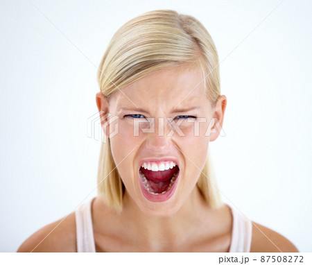 RAGE. Head and shoulders portrait of a furious woman screaming loudly. RAGE. Head and shoulders portrait of a furious woman screaming loudly. 87508272