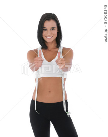 I did it - Fitness Weight loss. A fit young woman giving two thumbs up while isolated on white with a measuring tape around her neck. I did it - Fitness Weight loss. A fit young woman giving two thumbs up while isolated on white with a measuring tape around her neck. 87508348