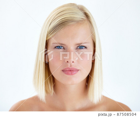 Framing natural beauty. Head and shoulders portrait of a pretty young blonde staring at your seriously. Framing natural beauty. Head and shoulders portrait of a pretty young blonde staring at your seriously. 87508504