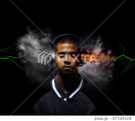 Music beats explode my mind. Digitally enhanced image of a young man listening to music exploding from his head phones. Music beats explode my mind. Digitally enhanced image of a young man listening to music exploding from his head phones. 87509108