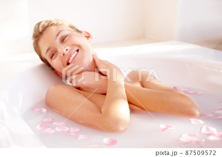 This is simply amazing. A gorgeous young woman lying in a luxurious bath of rose petals. 87509572