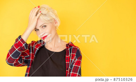 Facepalm gesture. Confused woman. Clueless situation. Embarrassed beautiful lady covering face with hand feeling epic fail isolated yellow copy space. Facepalm gesture. Confused woman. Clueless situation. Embarrassed beautiful lady covering face with hand feeling epic fail isolated yellow copy space. 87510326