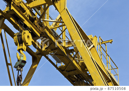 Metal construction of the crane, against the sky, in the warehouse 87510508