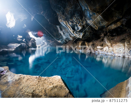 Blue waters of Grjotagja Cave in Iceland 87511275
