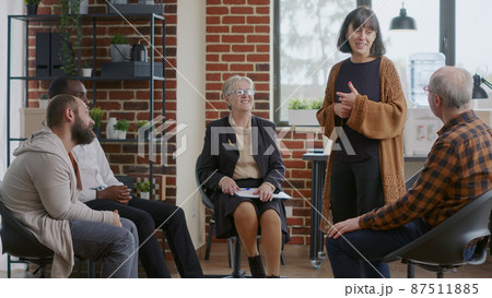 Woman sharing therapy progress with group at aa meeting and receiving applause Woman sharing therapy progress with group at aa meeting and receiving applause 87511885