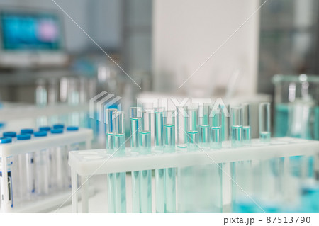 Group of test tubes containing light blue liquid substance 87513790