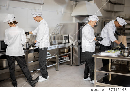 Happy multiracial team of cooks actively work in the kitchen 87515143