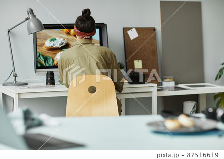 Female Photographer Editing Photos Back View 87516619