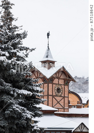 Detailed view of an ancient wooden town hall with an antique clock. Famous tourist place and a place for romantic travel. Popular tourist destination in Chortkiv, Ukraine Detailed view of an ancient wooden town hall with an antique clock. Famous tourist place and a place for romantic travel. Popular tourist destination in Chortkiv, Ukraine 87518642
