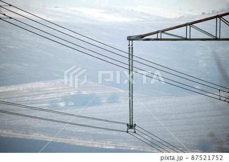Electric power lines divided by safe guard insulating frame transfening safely high voltage electrical energy through cable wires. Electricity transmission on long distance concept Electric power lines divided by safe guard insulating frame transfening safely high voltage electrical energy through cable wires. Electricity transmission on long distance concept 87521752