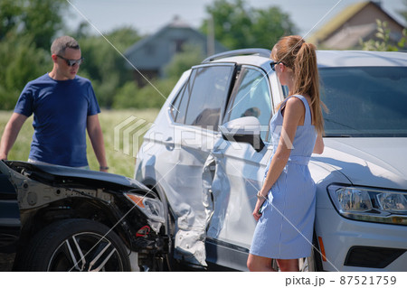 Drivers of smashed vehicles arguing who is guilty in car crash accident on street side. Road safety and insurance concept Drivers of smashed vehicles arguing who is guilty in car crash accident on street side. Road safety and insurance concept 87521759