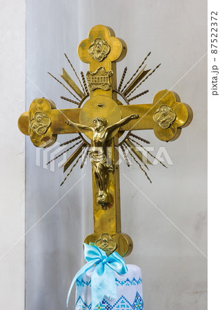 metal cross. golden color. Jesus, light background 87522372